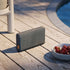 Steel-colored Move 50 Care portable speaker with biodegradable frame and silicone buttons.