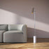 Polished Expo Floor lamp with aluminum body and marble base standing on a floor.