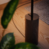 Black SACKit Expo 185 floor lamp with slim aluminum profile and marble base standing indoors.