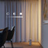 White SACKit Expo 185 floor lamp with slim aluminum body and marble base emitting soft upward LED light