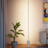 White SACKit Expo 185 floor lamp with slim aluminum profile and marble base emitting soft upward light