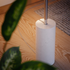 Sleek polished aluminum floor lamp with vertical frosted LED strip and marble base, minimalist indoor lighting.