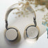 sackit Touch 400 over ear headphones in beige and gray with cushioned ear cups and a textured headband displayed on a light surface