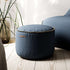 Round Cura Pouf in dark blue Cura fabric with soft texture and hand-sewn linen stitches.