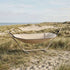 sackit Cobana hammock in soft beige fabric on a stand among coastal dunes and grass for comfortable outdoor lounging