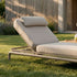 Beige Kirra sunbed with reclining backrest and soft cushions on a lawn in warm sunlight designed for comfortable outdoor relaxation by sackit
