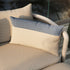 Sand and indigo color block Tide Cushion made of durable outdoor fabric on a wooden bench.