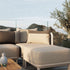 Sand and indigo color-blocked outdoor cushion with removable cover on a wooden surface