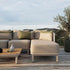 Tide Cushion in sand and indigo color blocks on outdoor lounge furniture