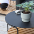 Outdoor patio sofa table with black powder-coated aluminum frame and teak wood shelf underneath