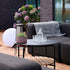 Outdoor patio sofa table with black powder-coated aluminum frame and teak wood shelf underneath