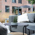 Outdoor patio sofa table with black powder-coated aluminum frame and teak wood shelf underneath