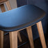 Nordic bar stool in oak with Terra Black leather seat and powder-coated steel footrest.