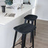 Nordic bar stool in black stained oak with Terra Black leather upholstery and powder-coated steel footrest.