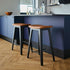 Nordic bar stool in black stained oak with Terra Black leather seat and powder-coated steel footrest.