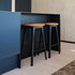 Nordic bar stool in black stained oak with Terra Black leather upholstery and powder-coated steel footrest.
