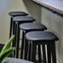Nordic bar stool in black stained oak with Terra Black leather seat and powder-coated steel footrest.
