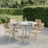 Round taupe Kirra Dining Table with teak wood top and powder-coated aluminum frame outdoors