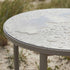 Kirra Dining Table in taupe powder-coated aluminum with teak wood top, round shape, outdoor setting