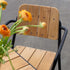 Kirra Patio Chair in black powder-coated aluminum and teak wood with armrests.