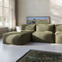 Olive green Soft Sofa Indoor with a spacious chaise lounge in a bright living room featuring a laptop and framed artwork by sackit