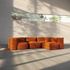 Orange four seat corner sofa with soft modular cushions in a sunlit modern interior designed by sackit for flexible indoor comfort