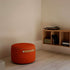 Round SACKit Pouf Indoor in orange jaquard fabric with a compact shape and soft texture.