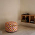 Round SACKit Pouf Indoor in Levanka textile with cold foam filling and side handle on a light floor