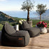 Cobana Lounge Chair and Pouf in Cobana Grey fabric with soft rounded shapes and hand-stitched details