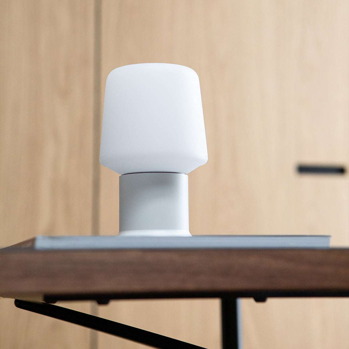 White Ambience Lamp Intelligent+ with London base in small size on a light surface
