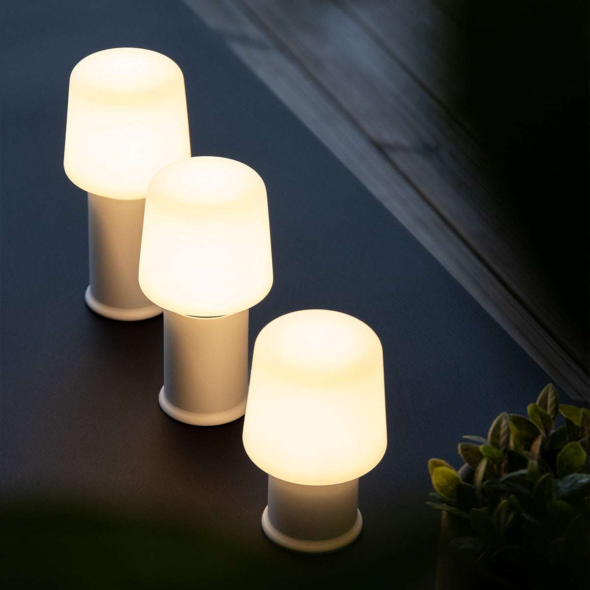 White Ambience Lamp Intelligent+ with London base in mixed sizes, sleek outdoor lighting with stainless steel details.
