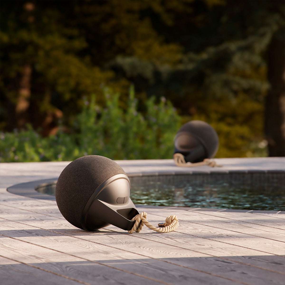 Black Play speaker with hemp rope handle and silicone buttons on a white background