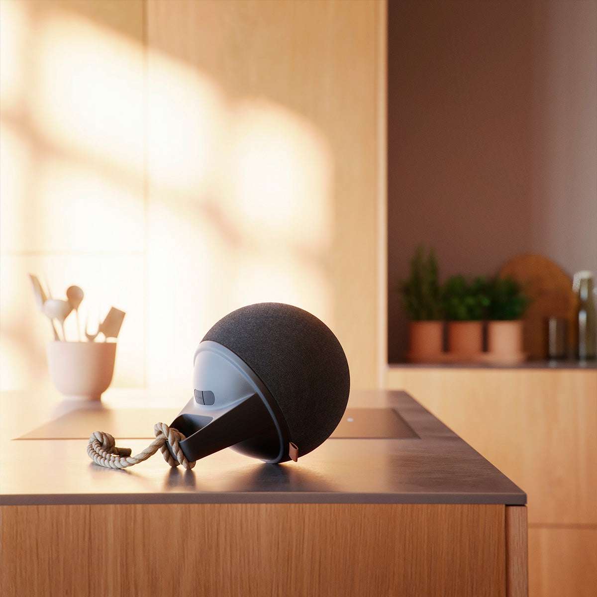 Black Play Bluetooth speaker with hemp rope handle and silicone buttons on a white background.