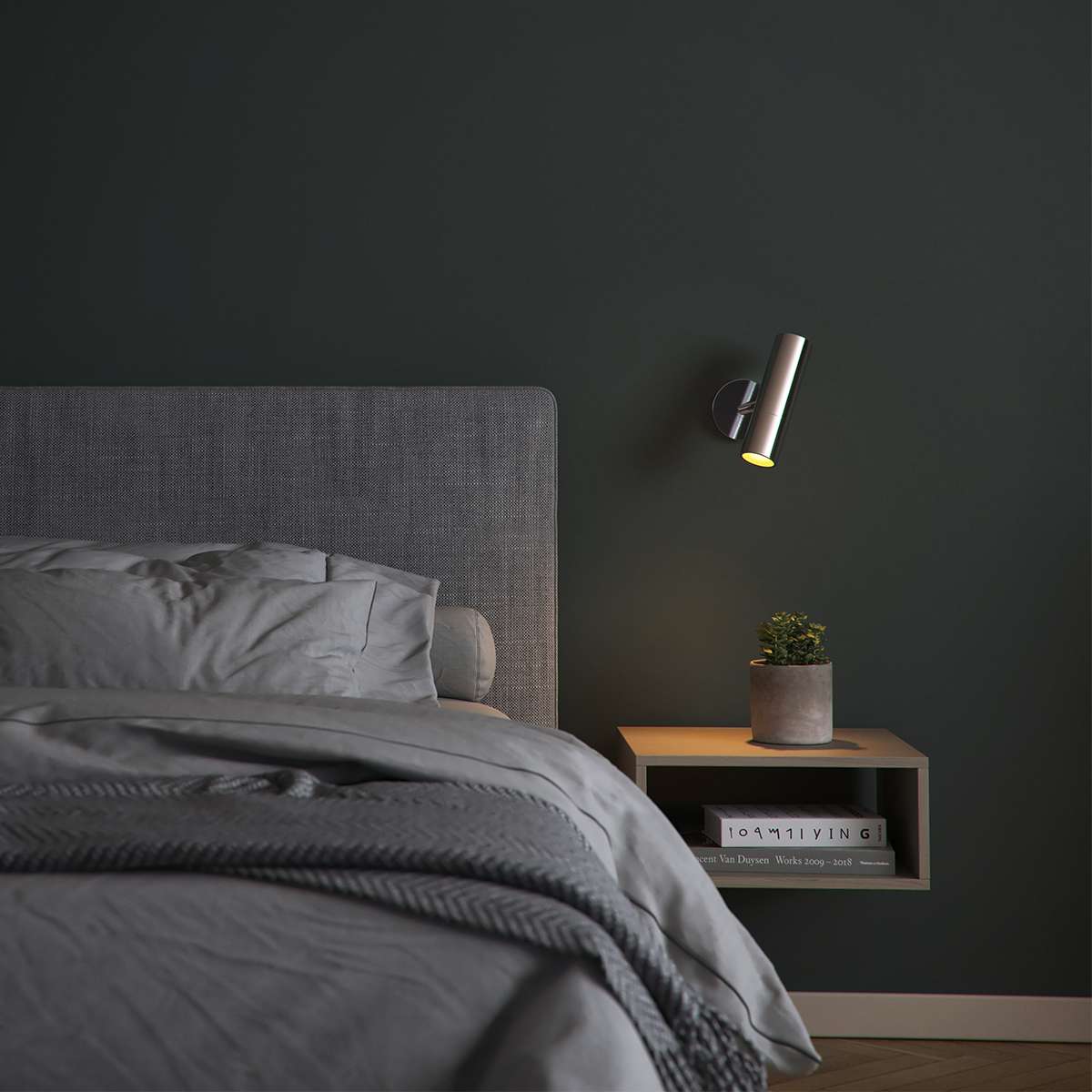 Polished aluminum Expo Wall light with sleek cylindrical design mounted on a wall.
