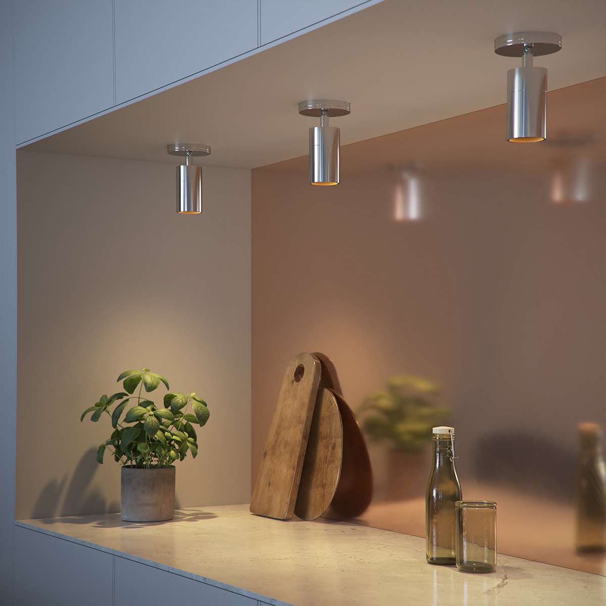 Polished aluminum Expo Ceiling light with a sleek round design mounted on a white ceiling.