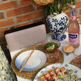 Move 150 speaker front panel in soft pink fabric resting on a white surface.