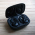 Black Active 200 wireless earbuds with charging case and USB cable on white background