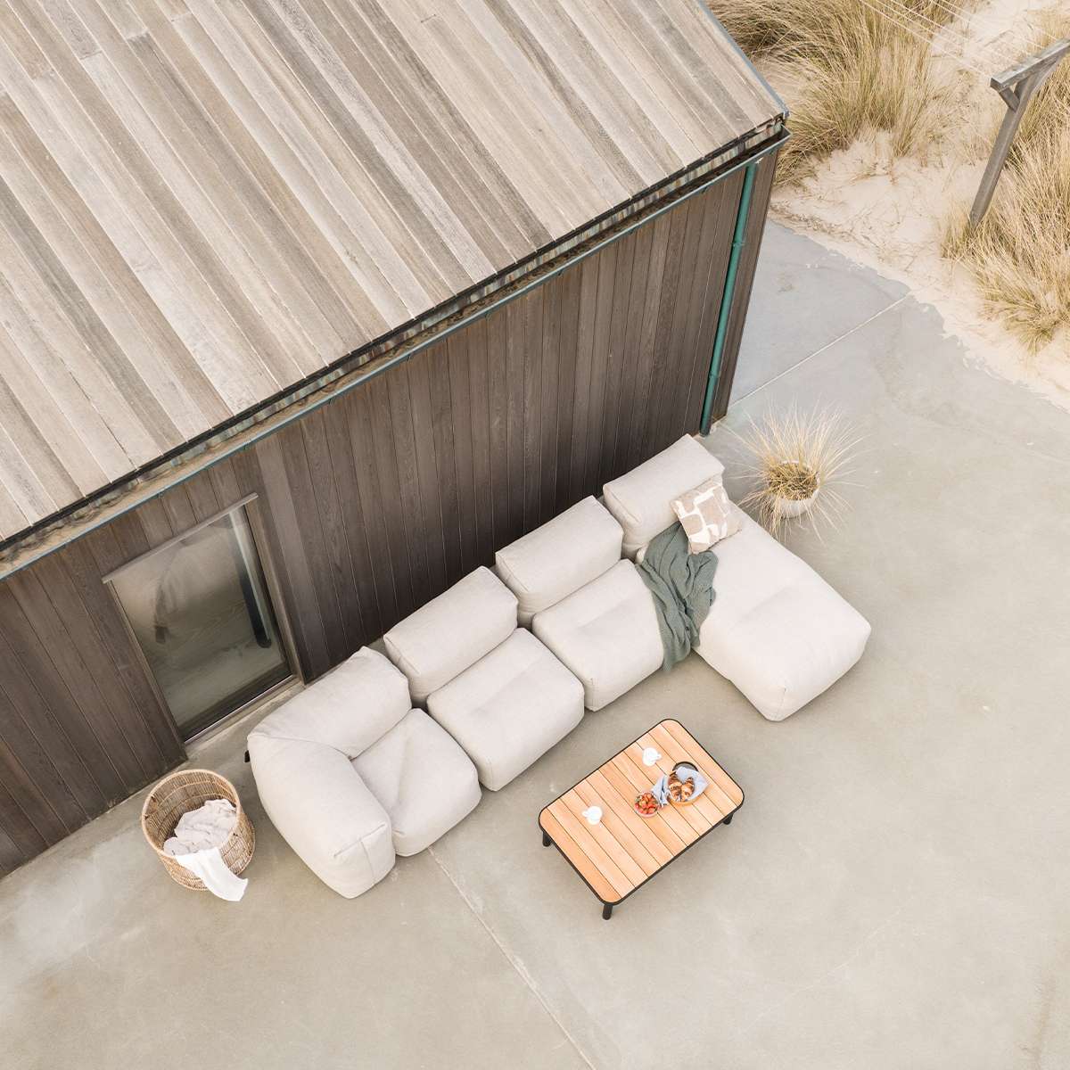 Soft Sofa Outdoor lounger in Kirra Sand color with soft cushions on a light background.