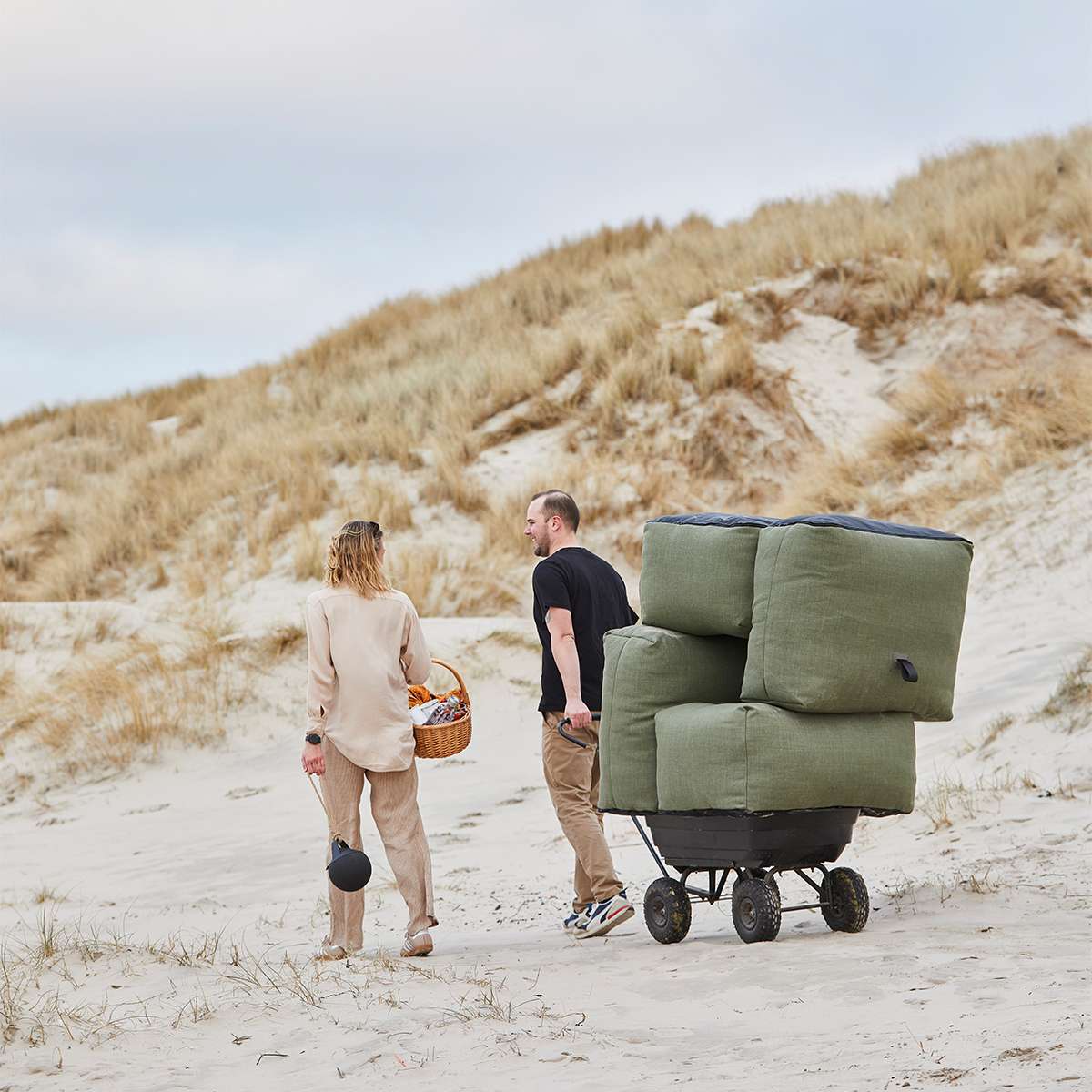 Soft Sofa Outdoor 2-seater in Kirra Olive fabric placed outdoors on a wooden deck.