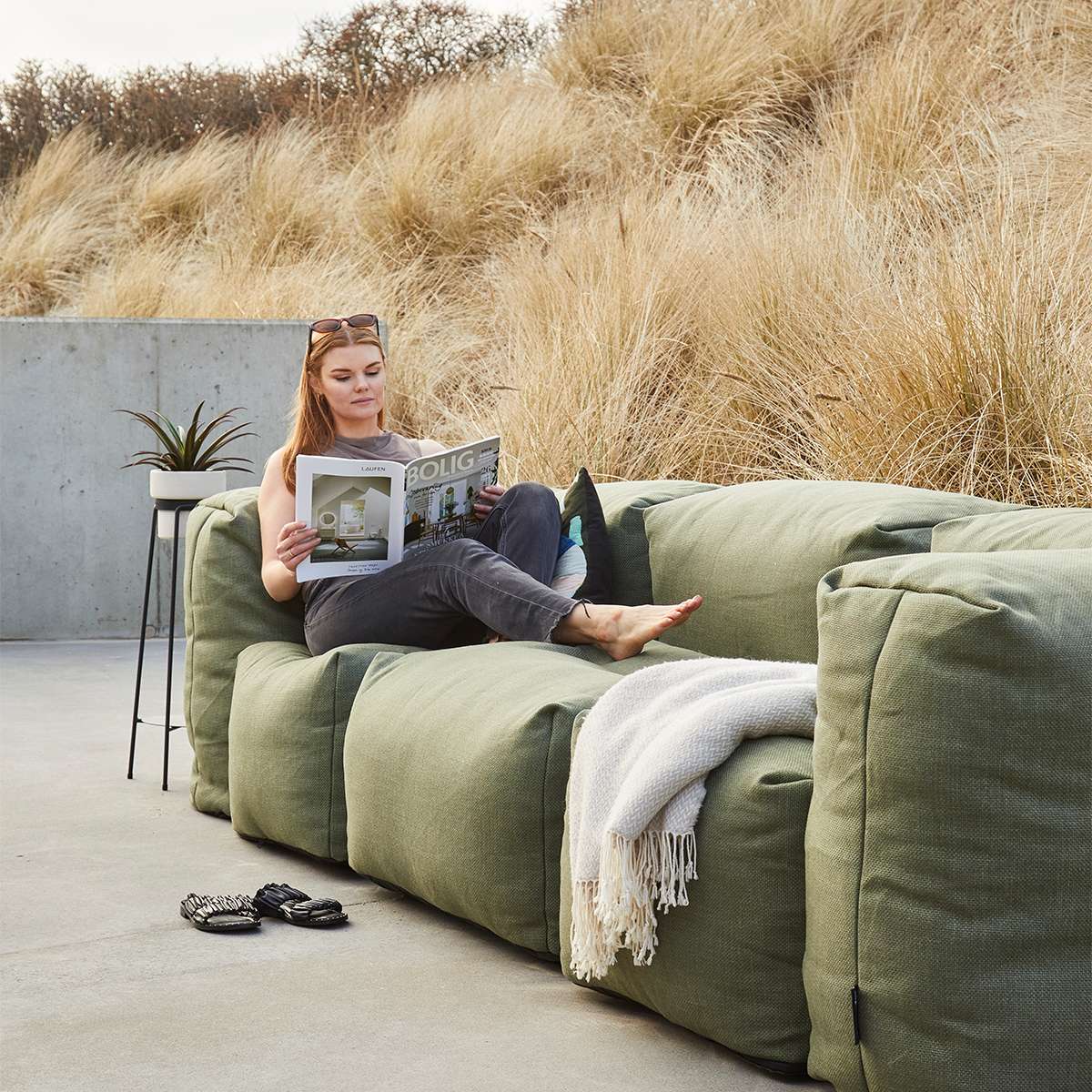 Soft Sofa Outdoor 3-seater in Kirra Olive fabric placed outdoors on a patio setting