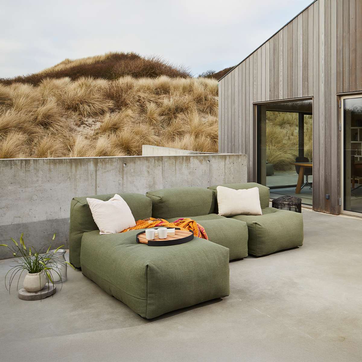 Soft Sofa Outdoor 3-seater with lounger in Kirra Olive fabric set outdoors on a wooden deck