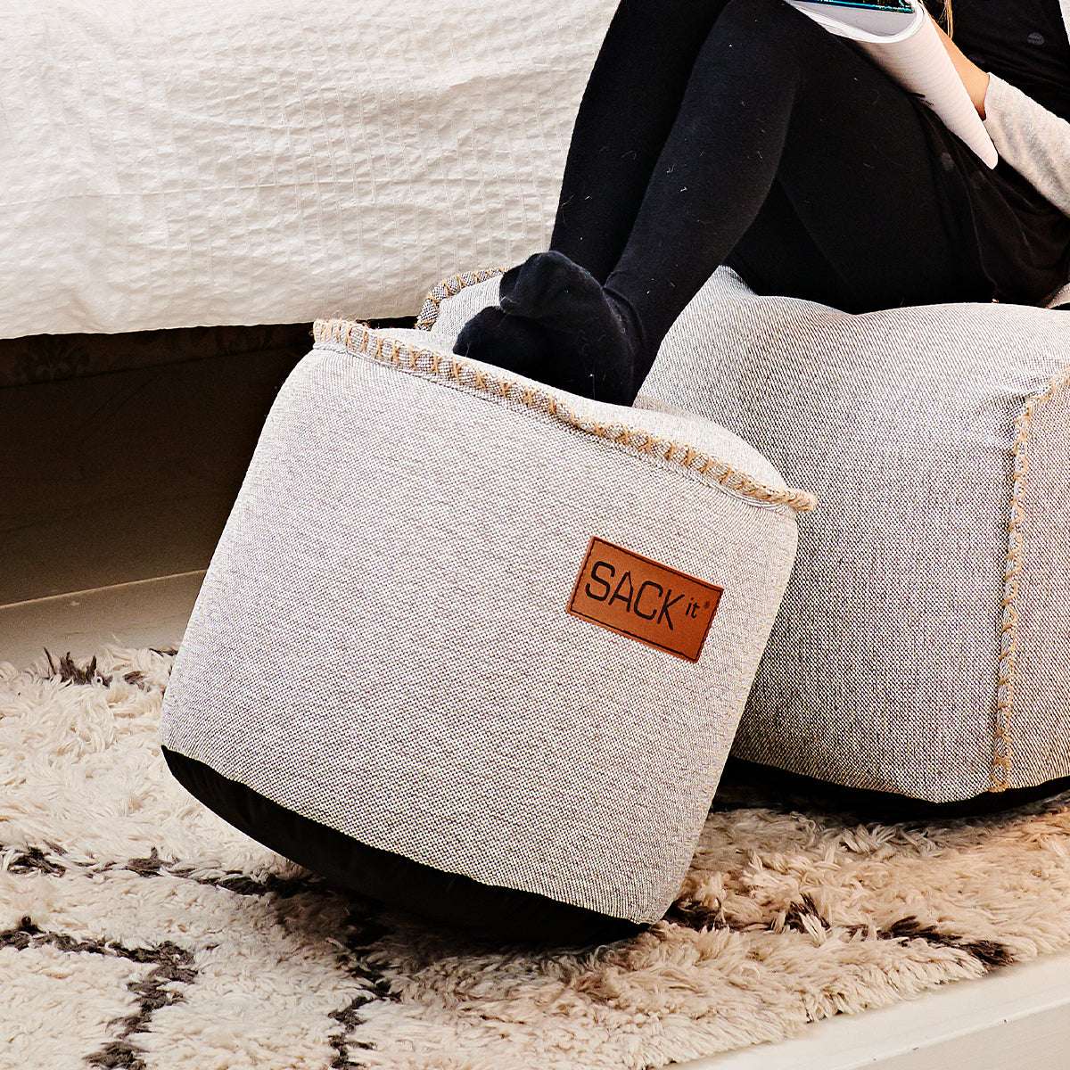 Cobana Junior Pouf in sand melange color with round shape and soft fabric surface.