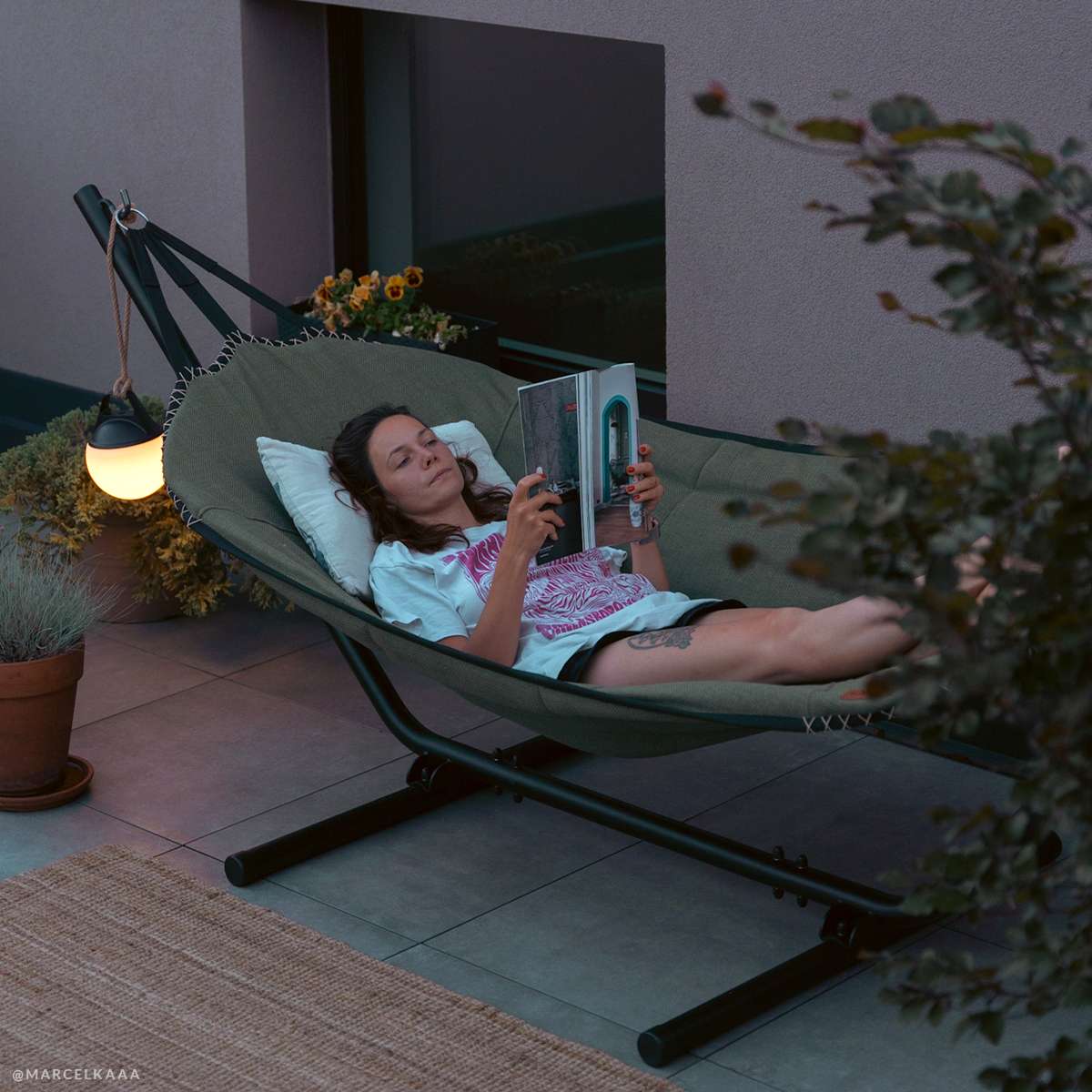 Cobana Hammock in grey olefin fabric with black powder-coated aluminum stand outdoors.