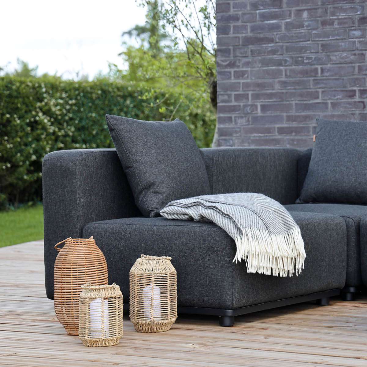 Cobana Lounge Sofa seat module in black powder-coated aluminum frame with dark fabric cushion outdoors
