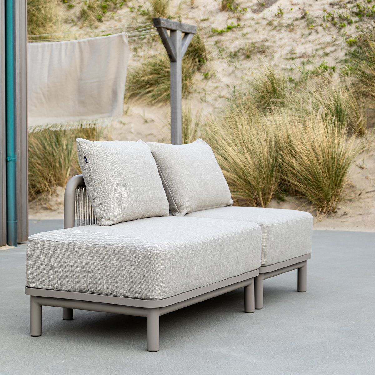 Kirra Lounge Sofa in Kirra Sand with open end right, powder-coated aluminum frame and olefin textile cushions outdoors