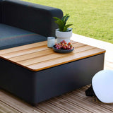 Modular outdoor Cobana Lounge Sofa with patio storage table in a garden setting
