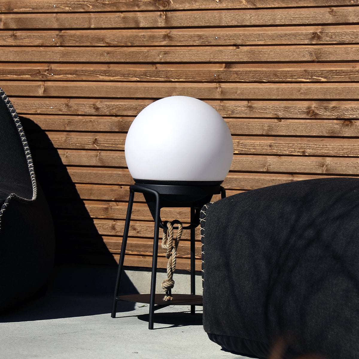 Black powder-coated stainless steel Patio Accessory Stand with a round base and light dome on top