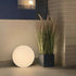 Round outdoor Light 350 lamp with white dome and rope handle on wooden surface