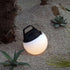 Round SACKit Light 250 outdoor lamp with hempen rope handle on wooden surface outdoors
