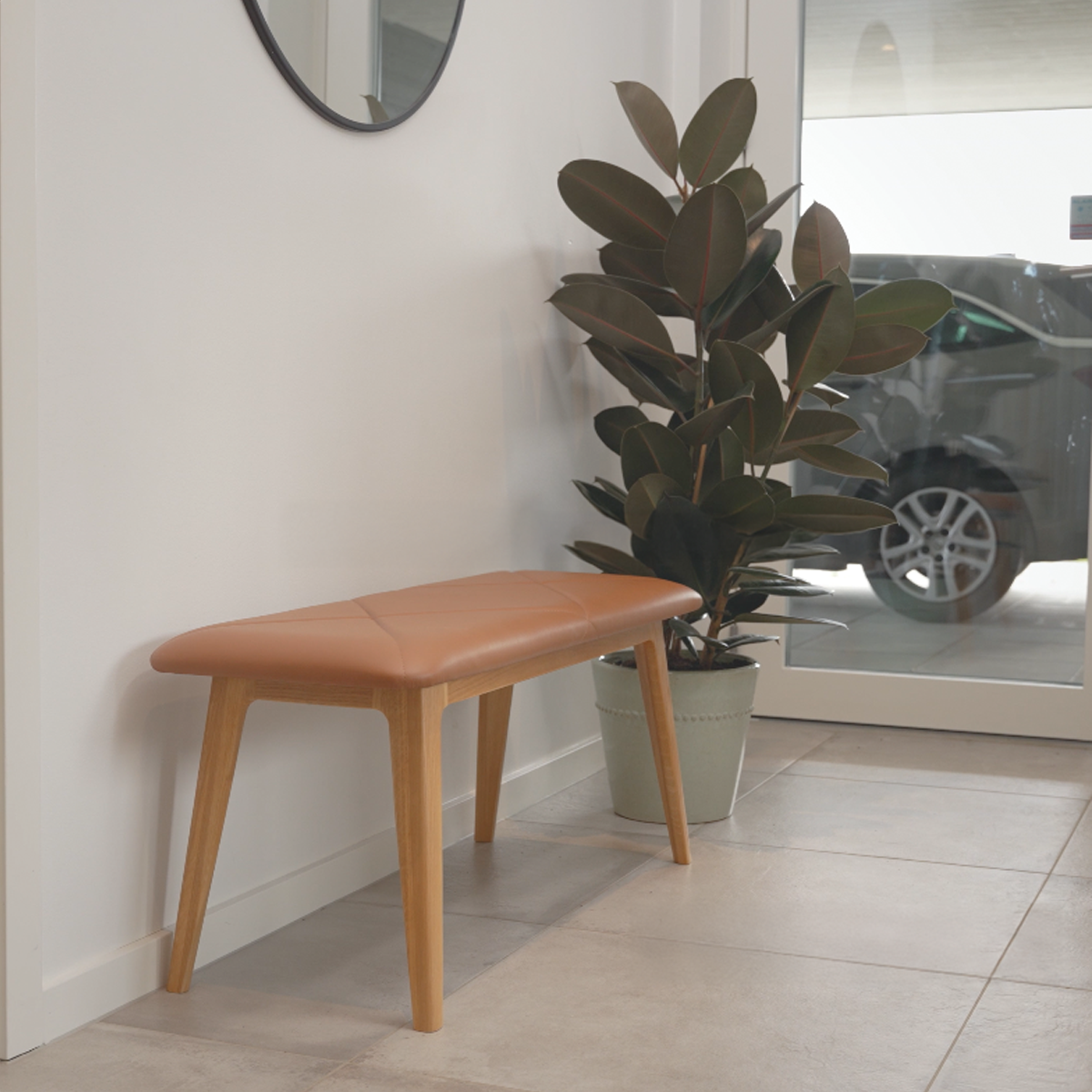 Nordic Bench with Terra Black leather seat and solid oak wood frame in a minimalist setting